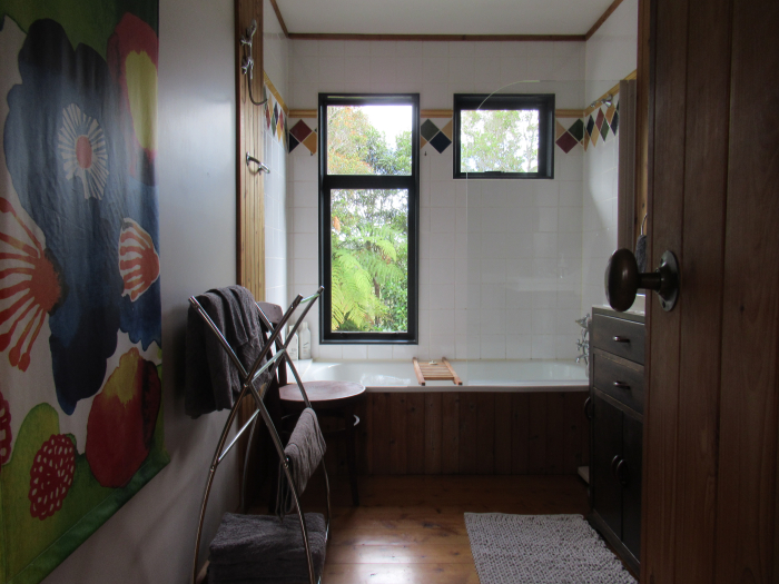 Photo of property: Cute bathroom with shower, toilet and bath with bush views